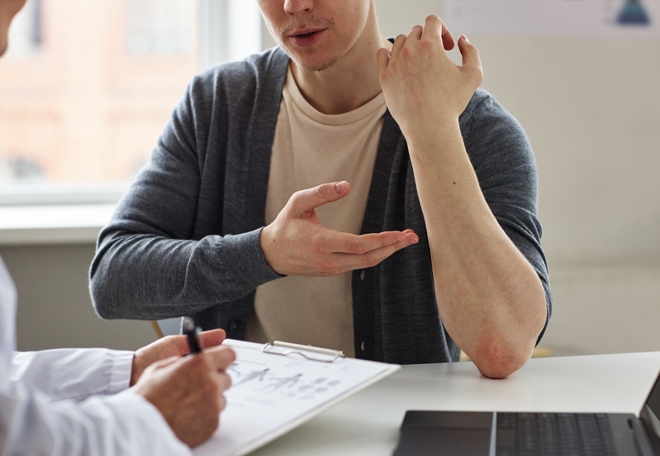 Patient showing doctor eczema on forearm